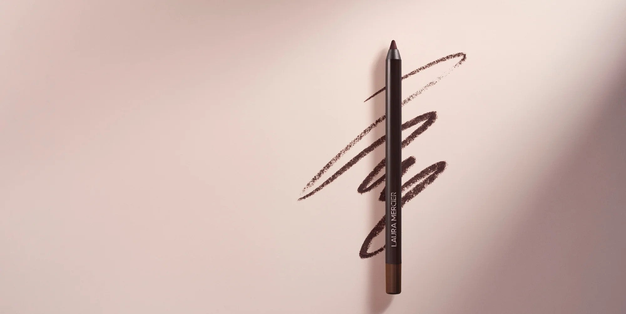 Stylized image of Laura Mercier Caviar Tightline Eyeliner with pink background and eyeliner squiggly swatch
